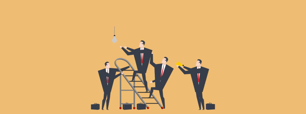 Four men in suits work together to change a light bulb; one stands on a ladder reaching for the bulb, while the others assist and observe, all on a plain tan background.